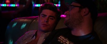 Movie still from “Neighbors” (2014), directed by Nicholas Stoller – Two men sitting next to each other on a couch; Close Up shot, Over the shoulder angle