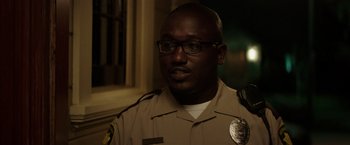 Movie still from “Neighbors” (2014), directed by Nicholas Stoller – A police officer is looking at the camera; Close Up shot, Over the shoulder angle