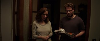 Movie still from “Neighbors” (2014), directed by Nicholas Stoller – A woman and a man standing next to each other; Medium shot, Over the shoulder angle