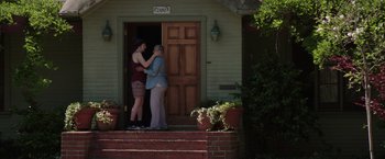 Movie still from “Neighbors” (2014), directed by Nicholas Stoller – Two women standing in front of a house; Wide shot, Low angle