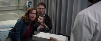Movie still from “Neighbors” (2014), directed by Nicholas Stoller – A man and a woman and a baby are sitting at a table; Medium shot, Over the shoulder angle