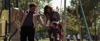 Movie still from “Neighbors” (2014), directed by Nicholas Stoller – A man and a woman pushing a baby on a swing; Wide shot, Over the shoulder angle
