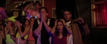 Movie still from “Neighbors” (2014), directed by Nicholas Stoller – A group of young people watching a movie; Medium shot, Over the shoulder angle