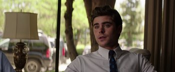 Movie still from “Neighbors” (2014), directed by Nicholas Stoller – A man wearing a white dress shirt and a blue tie; Close Up shot, Over the shoulder angle