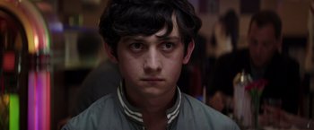 Movie still from “Neighbors” (2014), directed by Nicholas Stoller – A young man is looking into the camera; Close Up shot, Over the shoulder angle