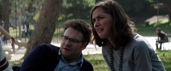 Movie still from “Neighbors” (2014), directed by Nicholas Stoller – A man and a woman sitting next to each other in a park; Close Up shot, Over the shoulder angle