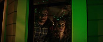 Movie still from “Neighbors” (2014), directed by Nicholas Stoller – A man and a woman looking out of a window; Medium shot, Low angle