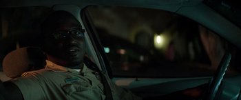 Movie still from “Neighbors” (2014), directed by Nicholas Stoller – A man sitting in the driver's seat of a car at night; Close Up shot, Over the shoulder angle