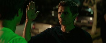 Movie still from “Neighbors” (2014), directed by Nicholas Stoller – A man with a green light on his face; Close Up shot, Over the shoulder angle