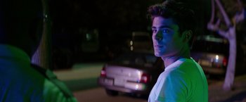 Movie still from “Neighbors” (2014), directed by Nicholas Stoller – A man standing in front of a car at night; Close Up shot, Over the shoulder angle