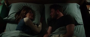 Movie still from “Neighbors” (2014), directed by Nicholas Stoller – A man and a woman laying in a bed together; Medium shot, Overhead angle