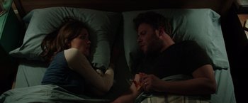 Movie still from “Neighbors” (2014), directed by Nicholas Stoller – A man and a woman laying in a bed together; Medium shot, Overhead angle