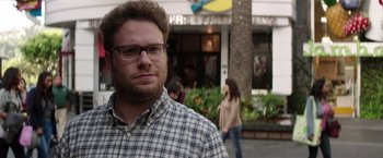Movie still from “Neighbors” (2014), directed by Nicholas Stoller – A person wearing glasses and a plaid shirt; Close Up shot, Over the shoulder angle