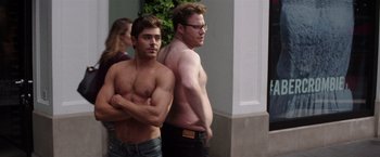 Movie still from “Neighbors” (2014), directed by Nicholas Stoller – Two shirtless men standing next to each other outside; Medium shot, Over the shoulder angle
