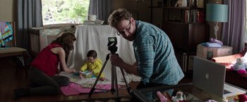 Movie still from “Neighbors” (2014), directed by Nicholas Stoller – A man is taking a picture of a child; Medium shot, Over the shoulder angle