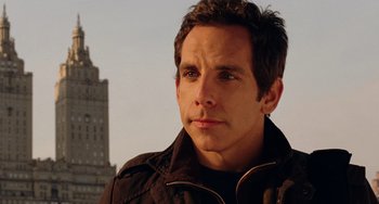 Movie still from “Night at the Museum” (2006), directed by Shawn Levy – A man that is standing in front of a tall building; Close Up shot, Over the shoulder angle