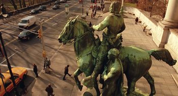 Movie still from “Night at the Museum” (2006), directed by Shawn Levy – A statue of a man riding a horse on a city street; Extreme Wide shot, High angle