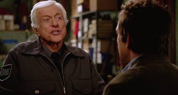 Movie still from “Night at the Museum” (2006), directed by Shawn Levy – A man talking to another man in front of a bookshelf; Close Up shot, Over the shoulder angle