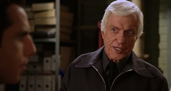 Movie still from “Night at the Museum” (2006), directed by Shawn Levy – An older man in a black shirt and jacket; Close Up shot, Over the shoulder angle