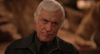 Movie still from “Night at the Museum” (2006), directed by Shawn Levy – An older man in a black shirt and a black tie; Close Up shot, Low angle