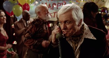 Movie still from “Night at the Museum” (2006), directed by Shawn Levy – An older man talking on a phone while another man looks on; Close Up shot, Over the shoulder angle