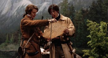 Movie still from “Night at the Museum” (2006), directed by Shawn Levy – Two people in costume are pointing to a map; Medium shot, Over the shoulder angle