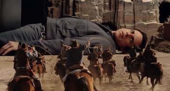 Movie still from “Night at the Museum” (2006), directed by Shawn Levy – A man is laying on the ground with a bunch of horses; Wide shot, Low angle