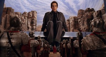 Movie still from “Night at the Museum” (2006), directed by Shawn Levy – Ben stiller sitting on top of a bench in front of a group of people; Wide shot, Low angle
