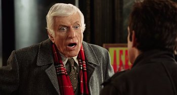 Movie still from “Night at the Museum” (2006), directed by Shawn Levy – An older man wearing a scarf and a jacket; Close Up shot, Over the shoulder angle