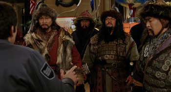 Movie still from “Night at the Museum” (2006), directed by Shawn Levy – A group of men dressed in traditional clothing; Medium shot, Over the shoulder angle