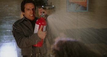 Movie still from “Night at the Museum” (2006), directed by Shawn Levy – A man holding a fire extinguisher in his hand; Medium shot, High angle