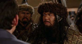 Movie still from “Night at the Museum” (2006), directed by Shawn Levy – A man with long hair and a beard wearing a horned hat; Close Up shot, Over the shoulder angle