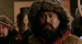 Movie still from “Night at the Museum” (2006), directed by Shawn Levy – A person wearing a hat and a beard; Close Up shot, Over the shoulder angle