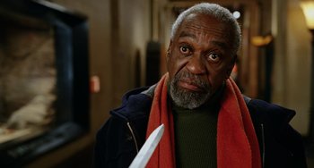 Movie still from “Night at the Museum” (2006), directed by Shawn Levy – An older man holding a knife in his hand; Close Up shot, Low angle