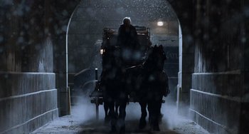 Movie still from “Night at the Museum” (2006), directed by Shawn Levy – A man riding a horse drawn carriage in the snow; Wide shot, Low angle