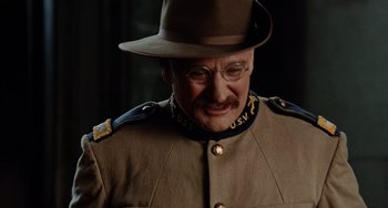 Movie still from “Night at the Museum” (2006), directed by Shawn Levy – An older man in a military uniform wearing a hat and eye glasses; Close Up shot, Over the shoulder angle