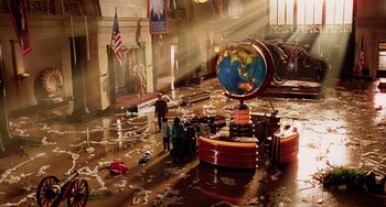 Movie still from “Night at the Museum” (2006), directed by Shawn Levy – A group of people standing around a globe in a room; Extreme Wide shot, High angle