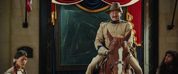 Movie still from “Night at the Museum: Battle of the Smithsonian” (2009), directed by Shawn Levy – A man in a uniform sitting on top of a horse; Medium shot, Low angle