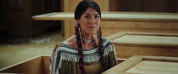 Movie still from “Night at the Museum: Battle of the Smithsonian” (2009), directed by Shawn Levy – A woman in native american clothing sitting in a room; Close Up shot, Over the shoulder angle