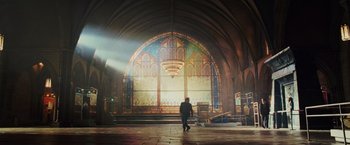 Movie still from “Night at the Museum: Battle of the Smithsonian” (2009), directed by Shawn Levy – A person standing in front of a stained - glass window; Extreme Wide shot, Low angle