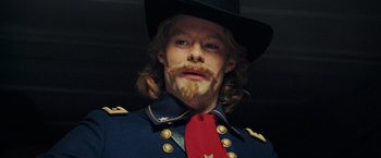 Movie still from “Night at the Museum: Battle of the Smithsonian” (2009), directed by Shawn Levy – A person wearing a uniform and a red tie; Close Up shot, Low angle