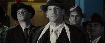 Movie still from “Night at the Museum: Battle of the Smithsonian” (2009), directed by Shawn Levy – A black and white photo of a man wearing a suit and hat; Close Up shot, Low angle