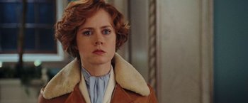 Movie still from “Night at the Museum: Battle of the Smithsonian” (2009), directed by Shawn Levy – A person with short hair wearing a jacket; Close Up shot, Over the shoulder angle