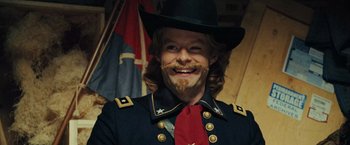Movie still from “Night at the Museum: Battle of the Smithsonian” (2009), directed by Shawn Levy – A man with a beard and mustache wearing a hat and a uniform; Close Up shot, Over the shoulder angle
