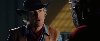 Movie still from “Night at the Museum: Battle of the Smithsonian” (2009), directed by Shawn Levy – A man wearing a cowboy hat and a vest; Close Up shot, Over the shoulder angle