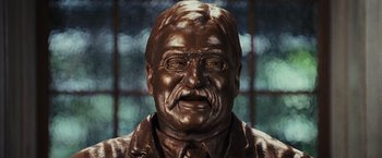 Movie still from “Night at the Museum: Battle of the Smithsonian” (2009), directed by Shawn Levy – A bronze statue of a man with a mustache; Close Up shot, Low angle