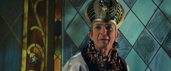 Movie still from “Night at the Museum: Battle of the Smithsonian” (2009), directed by Shawn Levy – A man wearing a gold and black hat with an eagle on it's head; Close Up shot, Low angle