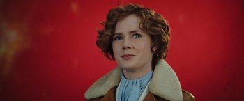 Movie still from “Night at the Museum: Battle of the Smithsonian” (2009), directed by Shawn Levy – A person with curly hair wearing a jacket; Close Up shot, Over the shoulder angle