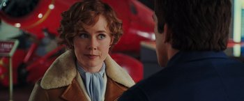 Movie still from “Night at the Museum: Battle of the Smithsonian” (2009), directed by Shawn Levy – A woman with short red hair wearing a brown jacket; Close Up shot, Over the shoulder angle