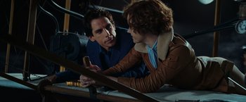 Movie still from “Night at the Museum: Battle of the Smithsonian” (2009), directed by Shawn Levy – A man and a woman looking at a piece of wood; Medium shot, High angle